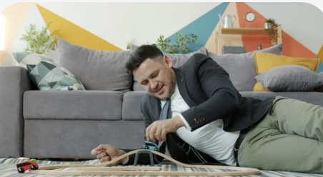 Adult in a suit engaged in a focused activity at home.